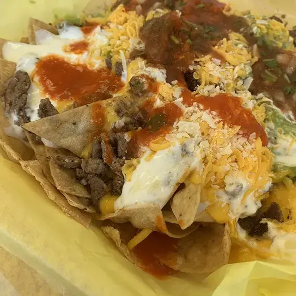 Loaded nachos with carne asada cheese guacamole and sour cream